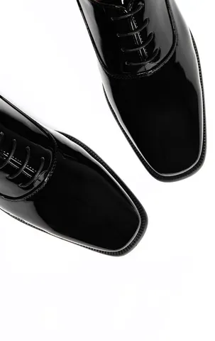 Men’s black wedding shoes with a glossy patent finish and lace-up fastening.